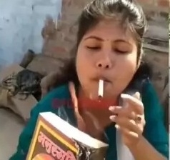 The Weekend Leader - Woman sets Manusmriti on fire, lights cigarette with it